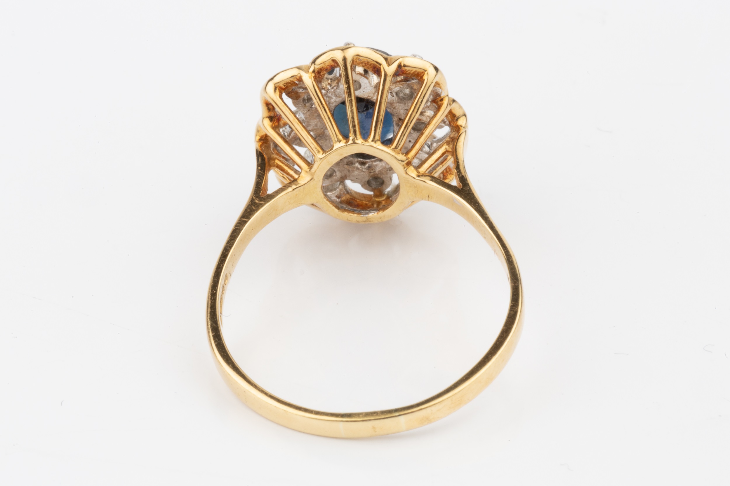 A sapphire and diamond dress ring, the oval central sapphire within a border of eight brilliant - Image 4 of 4