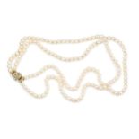 A twin strand uniform cultured pearl necklace, the 18ct yellow gold clasp linked by a diamond set