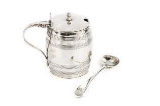 A George III silver mustard, of coopered barrel form, with hinged cover and blue glass liner, by