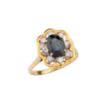 A sapphire and diamond dress ring, the oval central sapphire within a border of eight brilliant