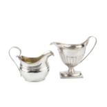 A George III silver cream jug, with shaped oval body, gadrooned border and reeded strap handle by