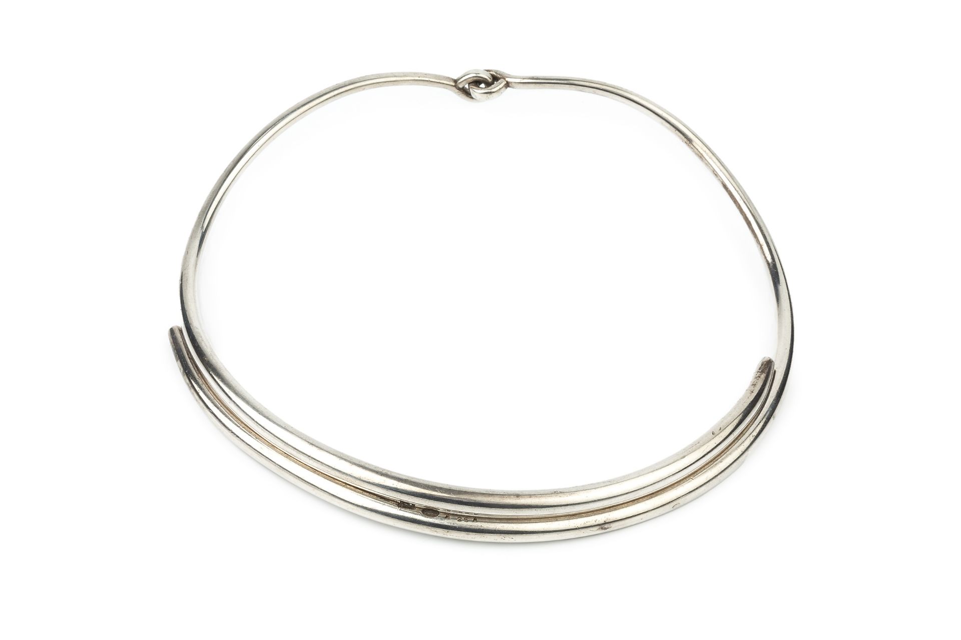 A Danish silver necklet by Georg Jensen, formed of two plain curved sections with loop hinge, no.