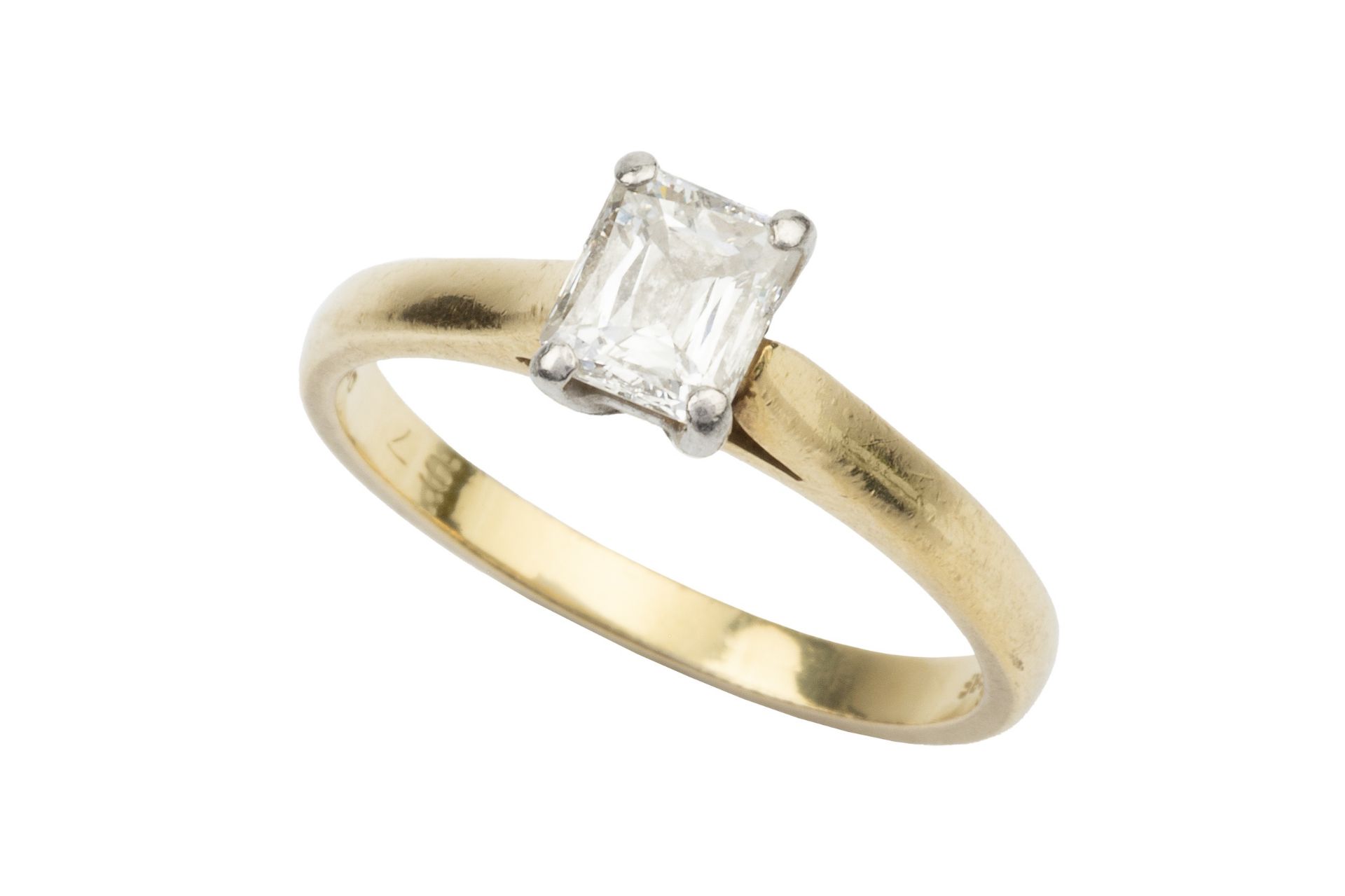 A diamond solitaire ring, the 'crisscut' emerald cut stone approx 0.7ct claw set in platinum to an