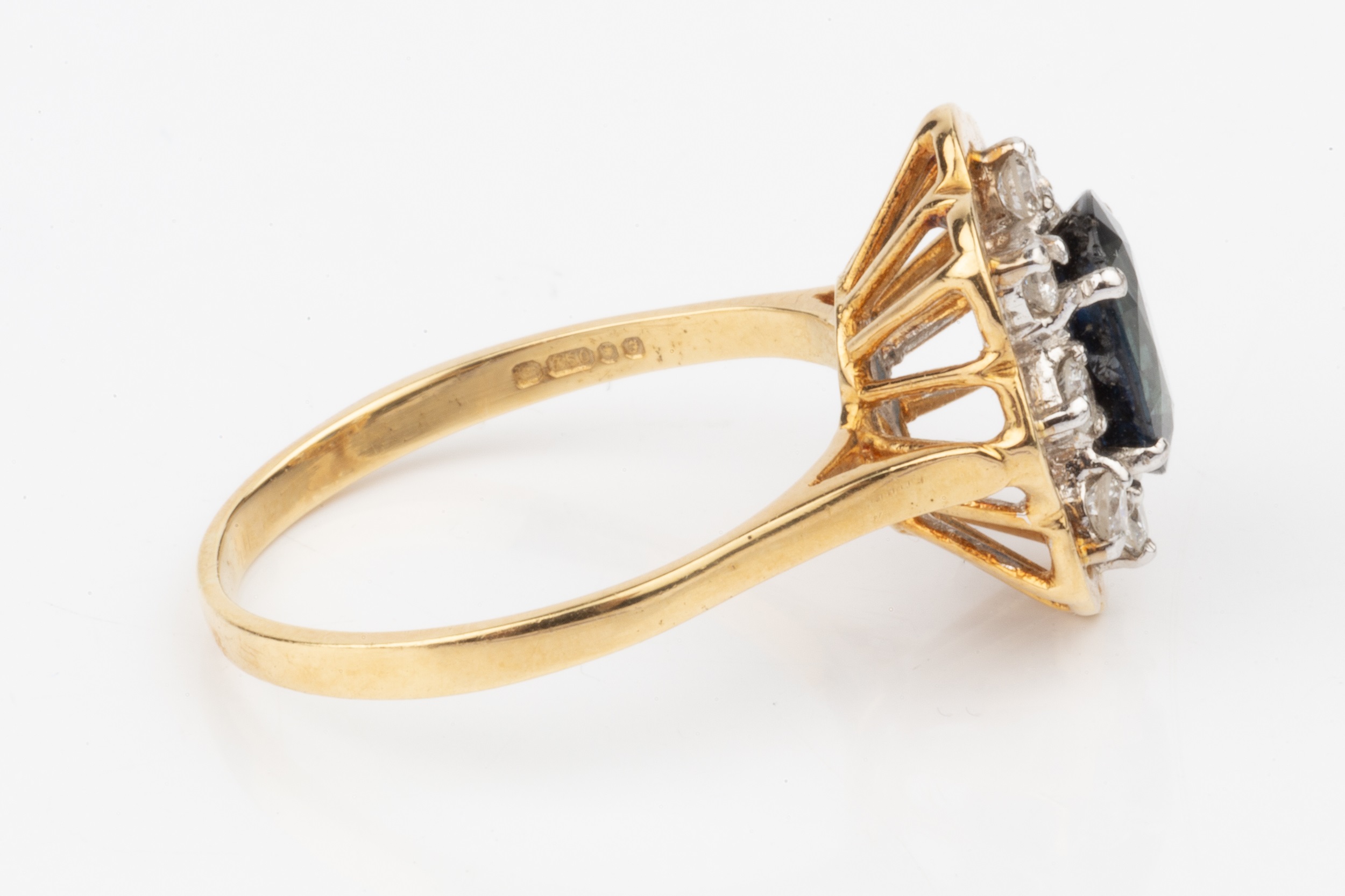 A sapphire and diamond dress ring, the oval central sapphire within a border of eight brilliant - Image 2 of 4