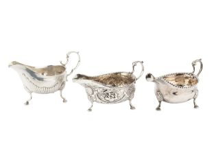 A George III silver sauce boat, with punched border and leaf capped scroll handle, on pad feet by