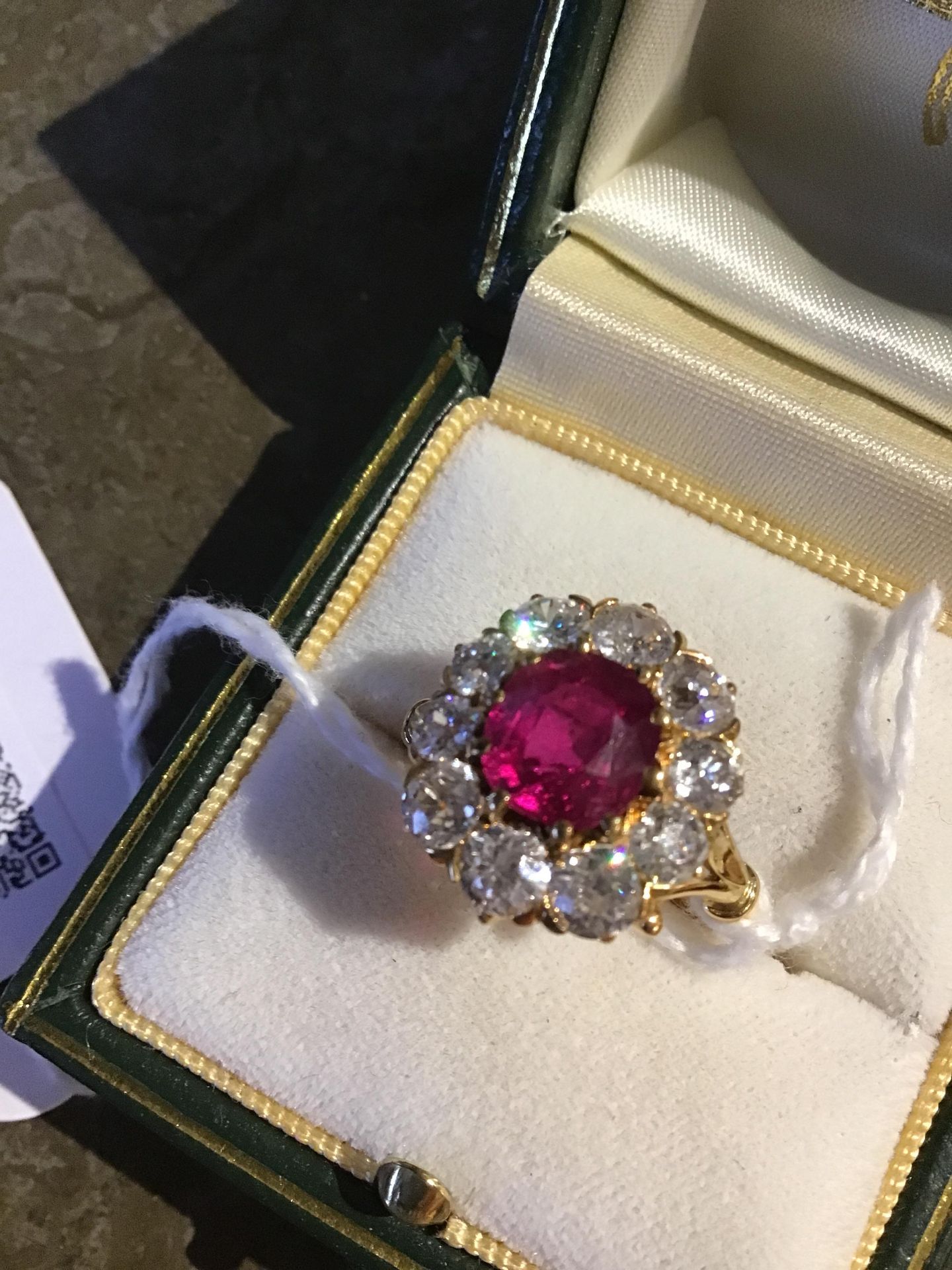 A ruby and diamond cluster ring, the central oval cut ruby within a border of ten old brilliant - Bild 9 aus 14