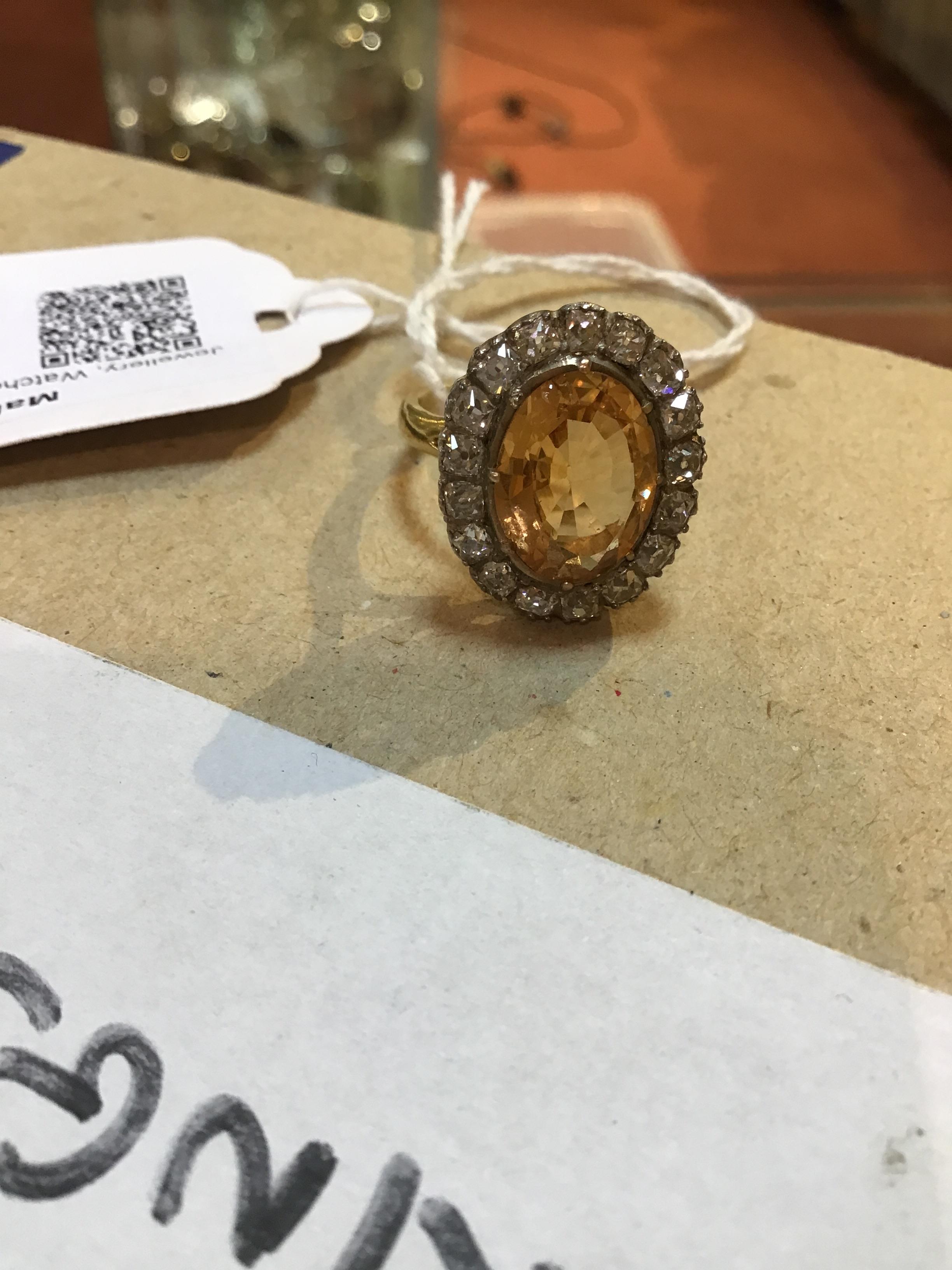 A topaz and diamond cluster ring, the oval central orange-brown topaz within a border of seventeen - Image 8 of 8