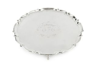 An Edwardian silver salver, with shaped border and pad feet, engraved presentation inscription, by