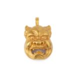 A 22k gold demon mask pendant and brooch, the half-human face with open jaws and fangs, the hinged