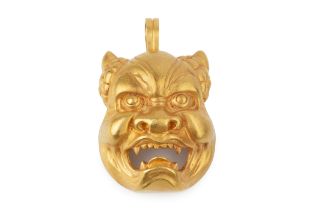 A 22k gold demon mask pendant and brooch, the half-human face with open jaws and fangs, the hinged