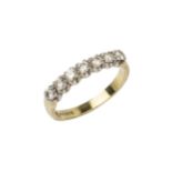 A diamond dress ring, set with a line of seven brilliant cut stones, to an 18ct yellow gold shank