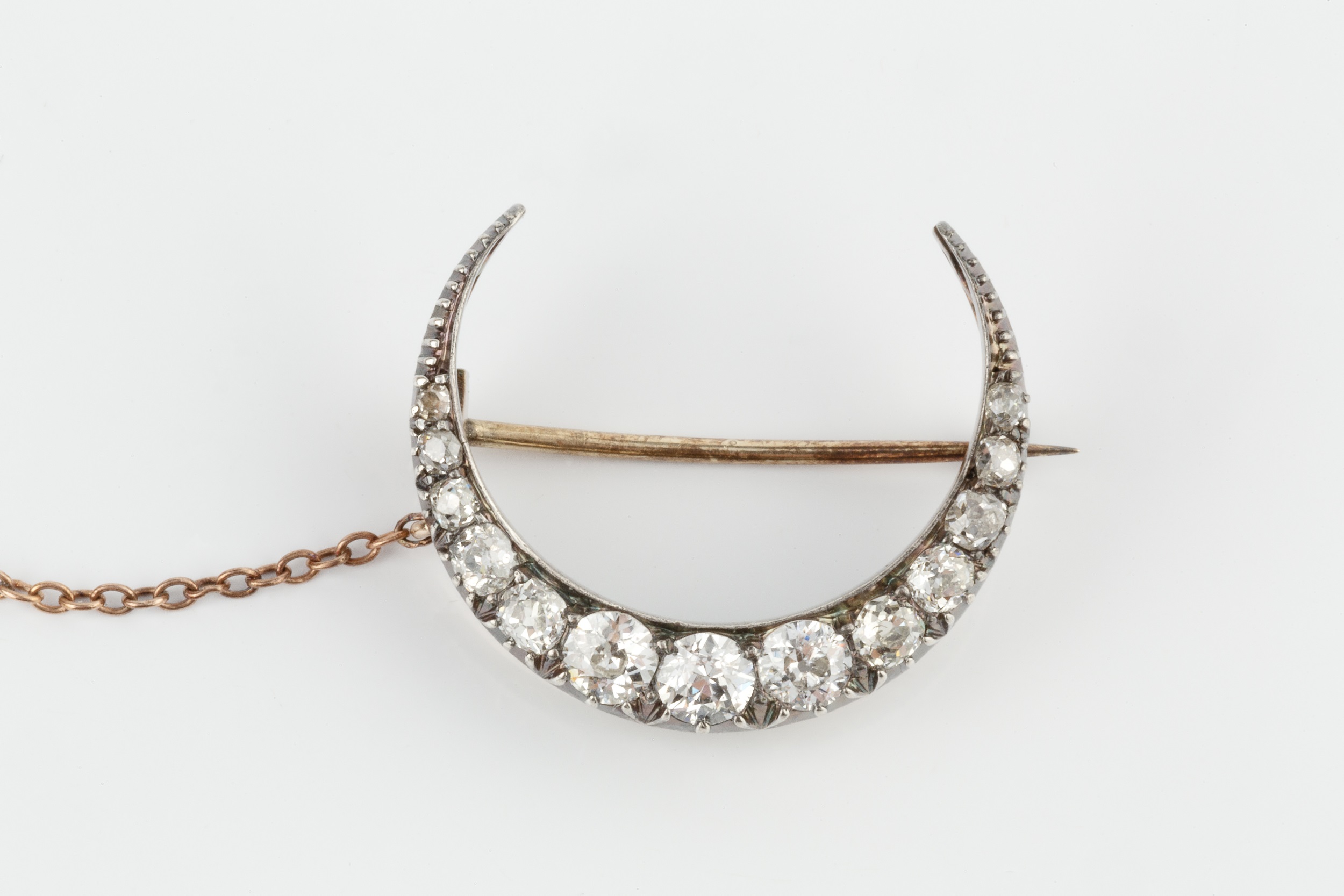 A diamond crescent brooch, set with thirteen graduated brilliant cut stones, the largest approx 0. - Image 3 of 3