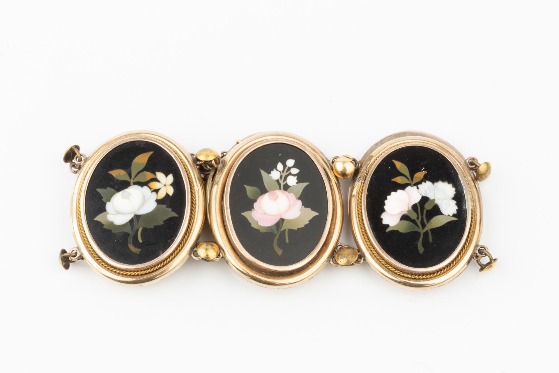 A pietra dura bracelet, the six oval panels inlaid with specimen floral sprays on a black ground, - Image 4 of 4