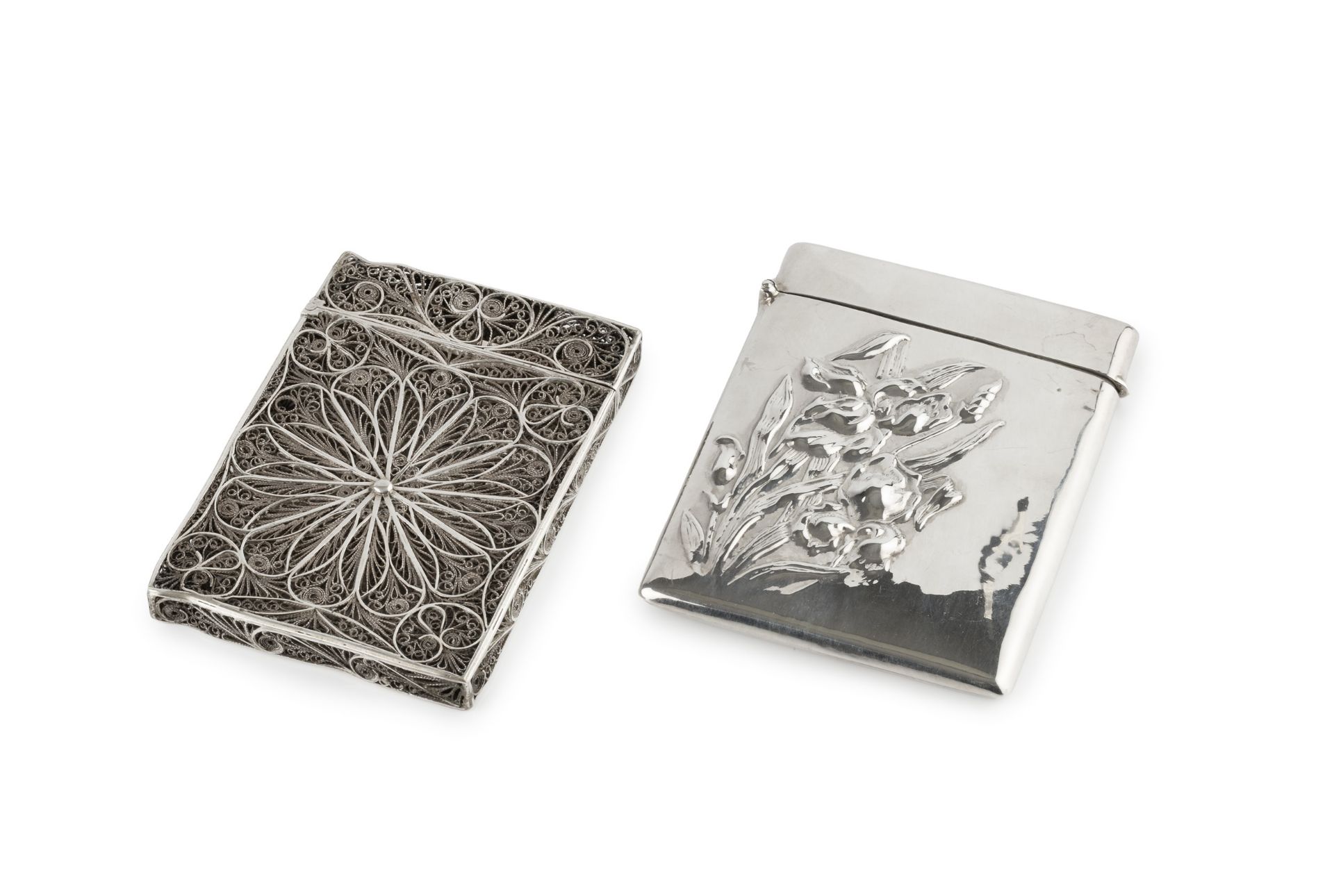 An early 20th century American silver card case, of slightly bowed rectangular form, embossed to the