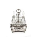 An early Victorian silver condiment stand, of oval form, embossed and chased with flowering