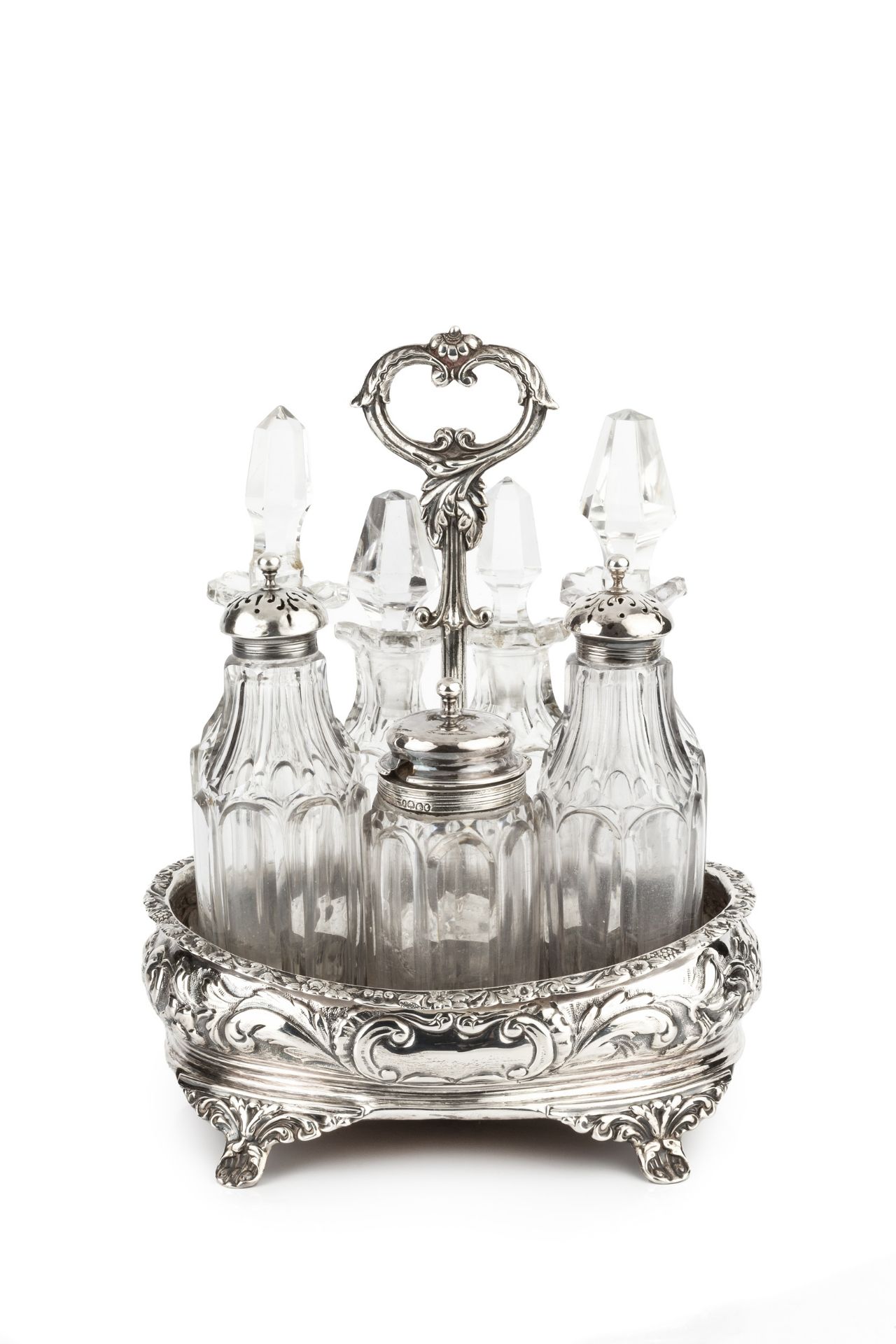 An early Victorian silver condiment stand, of oval form, embossed and chased with flowering