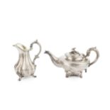 An early Victorian silver teapot, with reeded compressed body, foliate capped spout and floral