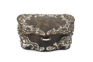 A late Victorian silver mounted tortoiseshell trinket box, of serpentine shaped outline and having