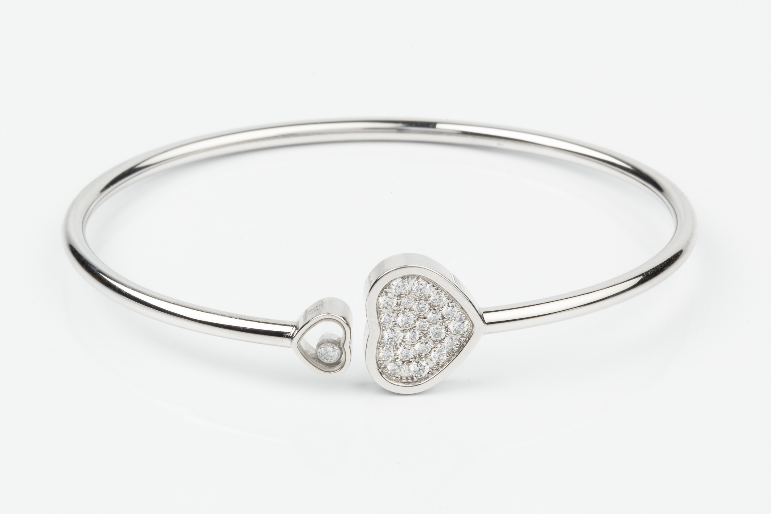 An 18ct white gold and diamond 'Happy Hearts' bangle by Chopard, the main heart terminal set with - Image 3 of 5