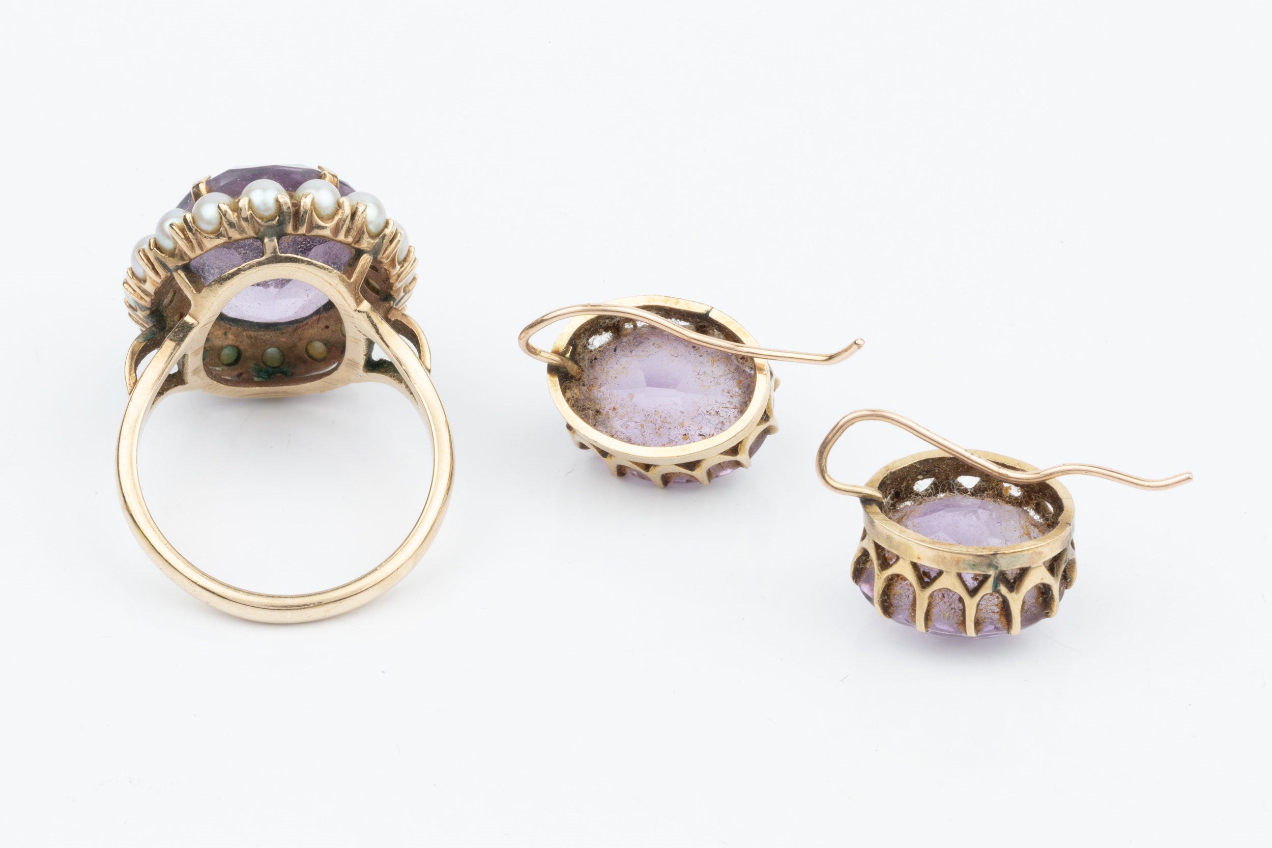 A 9ct gold, amethyst and pearl dress ring, the oval cut amethyst within a border of 16 small half - Image 2 of 3