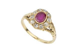 A ruby and diamond cluster ring, the oval cut ruby set within a border of ten old-cut diamonds, to
