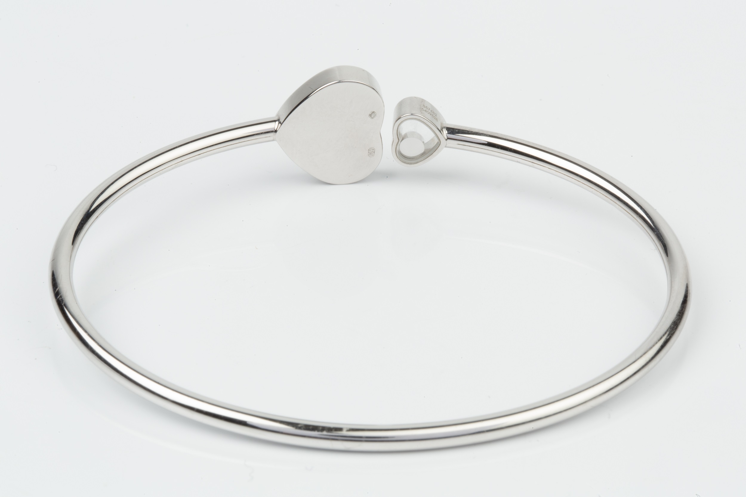 An 18ct white gold and diamond 'Happy Hearts' bangle by Chopard, the main heart terminal set with - Image 4 of 5