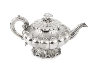 A William IV silver teapot, of lobed and compressed form, with shaped and engraved scalloped borders