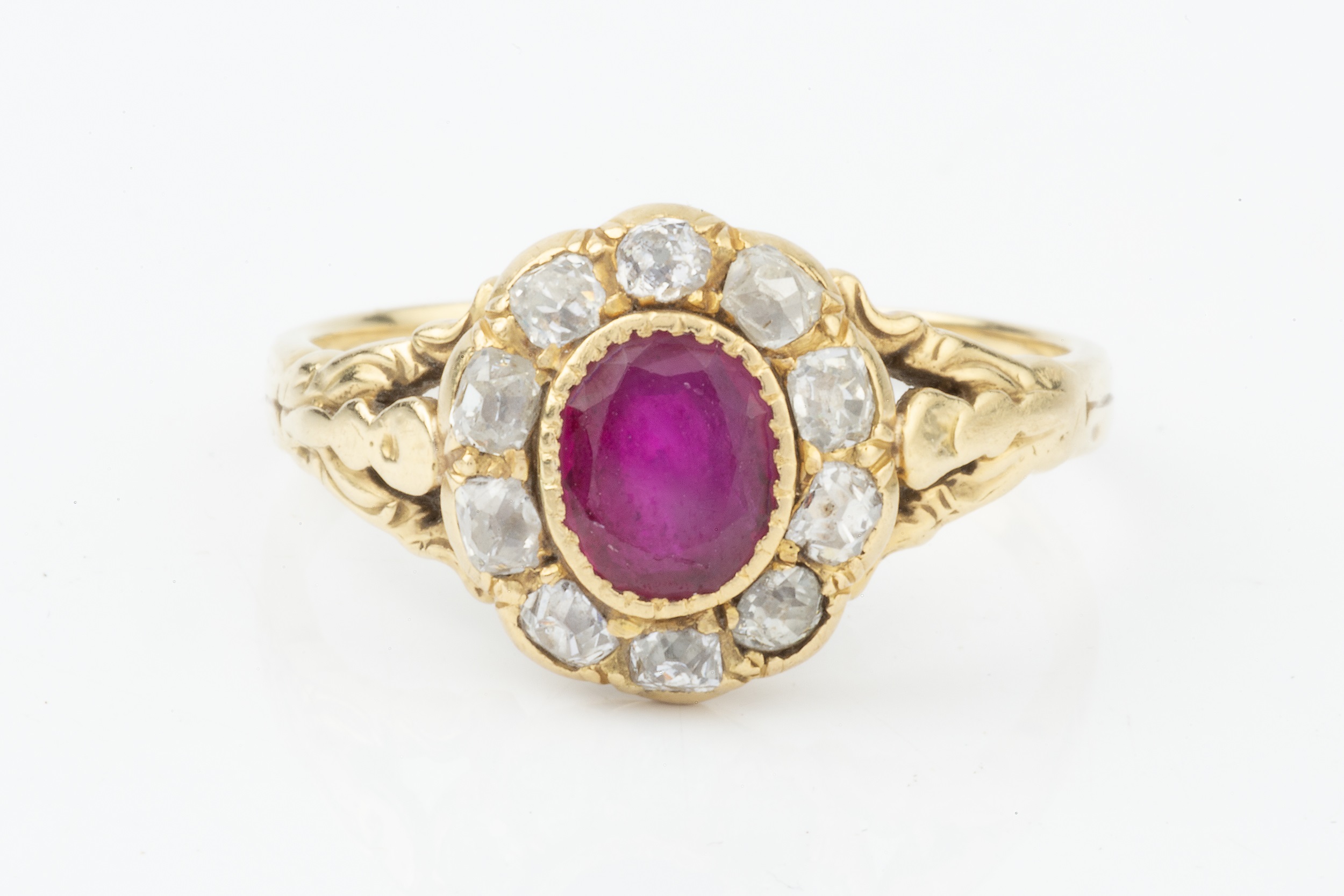 A ruby and diamond cluster ring, the oval cut ruby set within a border of ten old-cut diamonds, to - Image 4 of 4