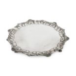 A George V silver salver, with shaped scroll and scalloped border, on claw and ball feet by Robert