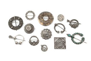A collection of five silver circular Celtic design brooches, modelled as cloak pins, three further