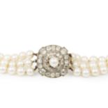 A cultured pearl three strand necklace with diamond clasp, the detachable circular clasp set with