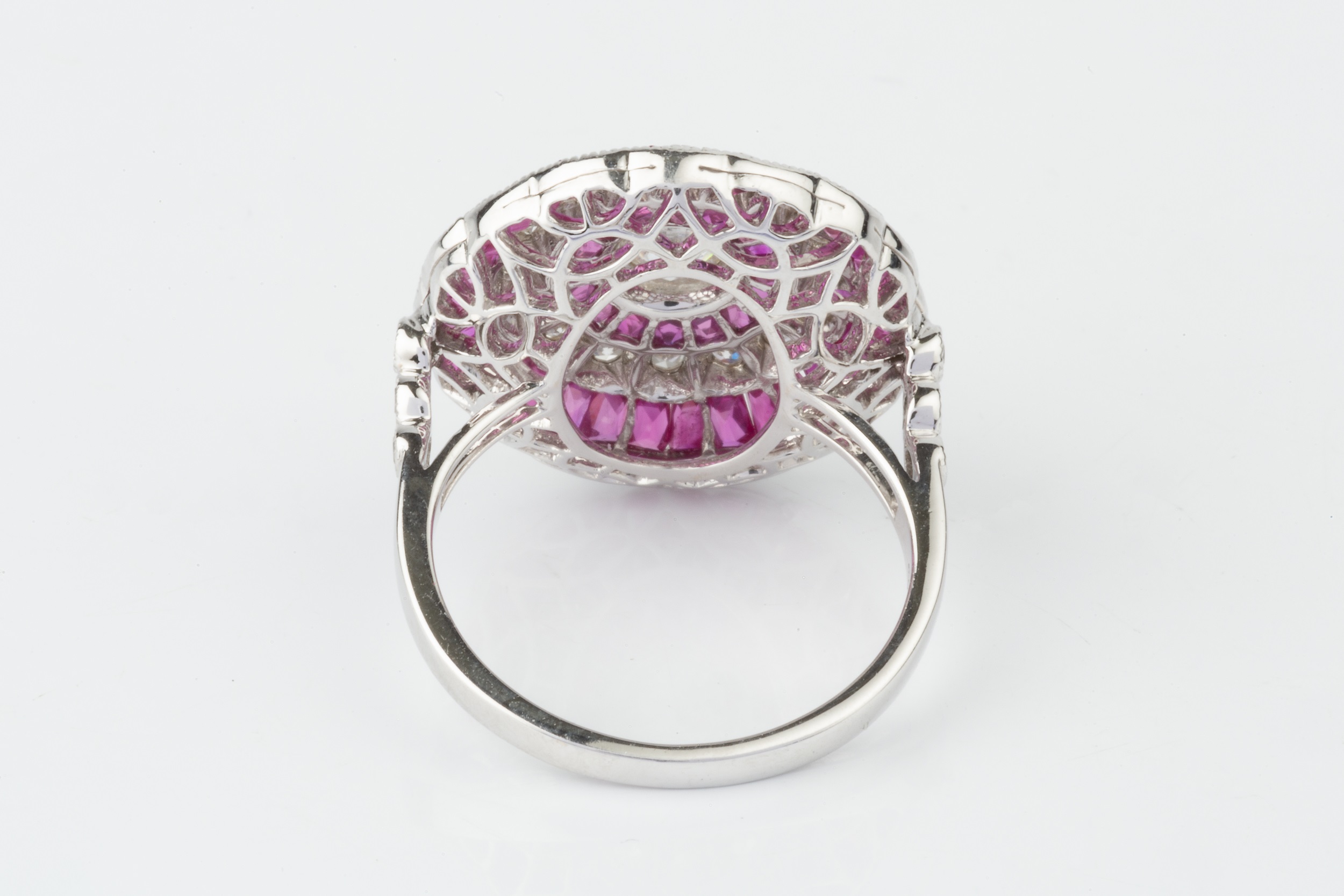 A ruby and diamond cocktail ring, of target design, centred with an old cut diamond within a - Image 4 of 4