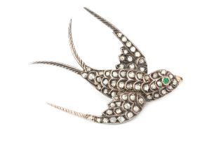 A 19th century diamond swallow brooch, set throughout with rose cut diamonds and with emerald set