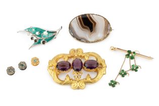 An amethyst brooch, the three oval cut stones within a foliate embossed yellow metal mount, 6.5cm