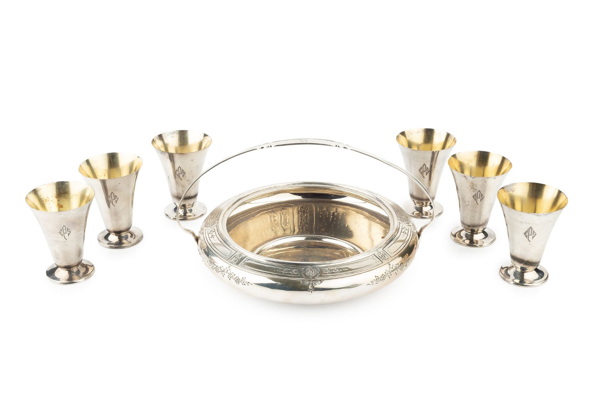 An American silver circular shallow bowl, with shaped fixed overhead handle, engraved with