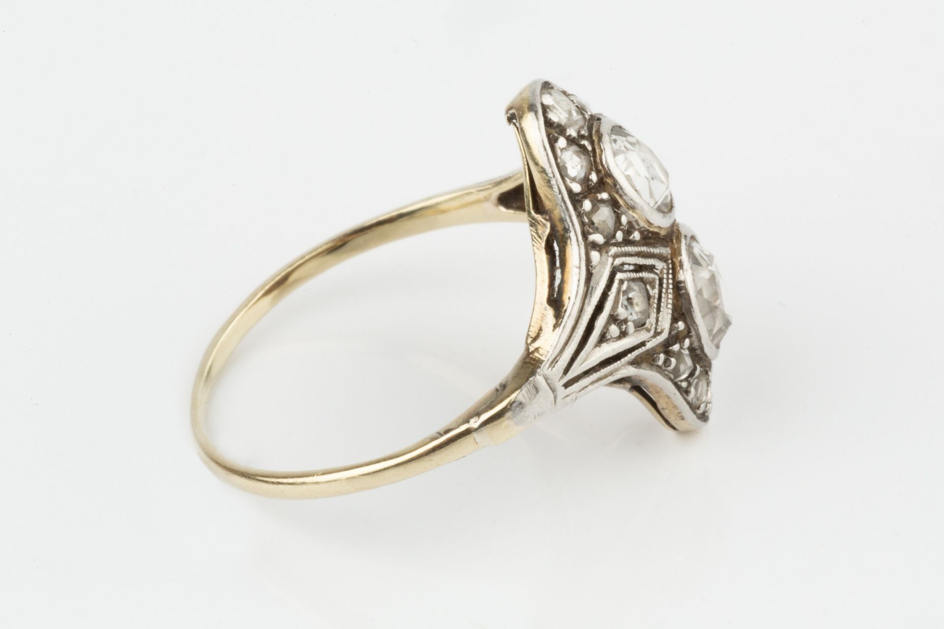 A diamond two stone ring, the two rose-cut stones set within a shaped border further set with - Image 3 of 4