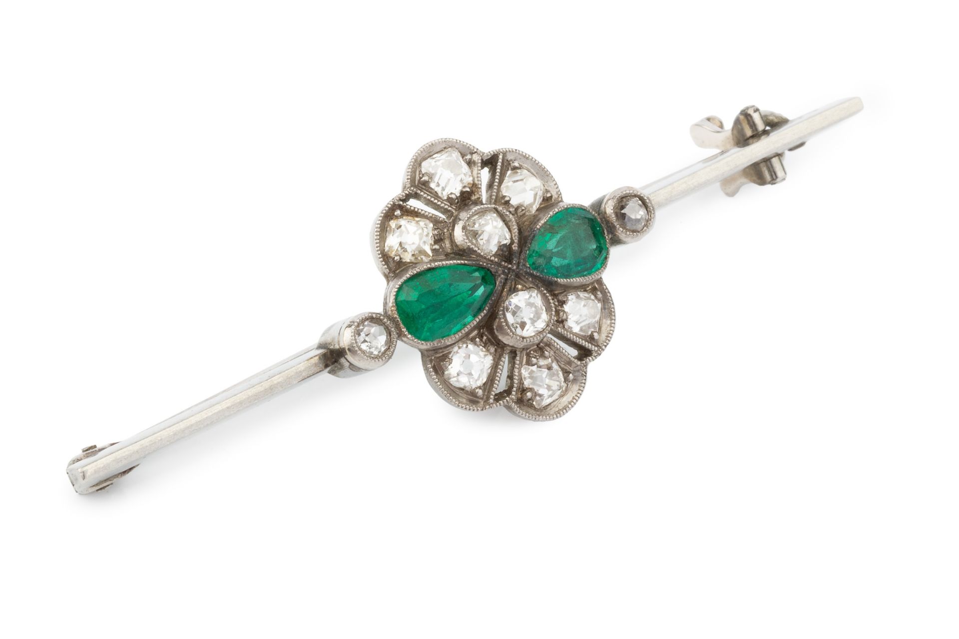 An emerald and diamond cluster bar brooch, the uniform bar centred with a pierced and millegrained