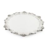 A George V silver large salver, with shaped scallop and scroll border, on foliate cast feet by Atkin