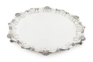 A George V silver large salver, with shaped scallop and scroll border, on foliate cast feet by Atkin