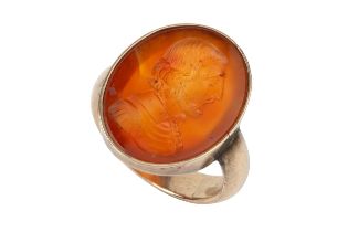 A 19th century carnelian seal ring, the oval carnelian plaque intaglio carved with a head and