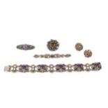 An Arts & Crafts design amethyst and pearl set bracelet, composed of circular white metal floral
