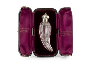 A late Victorian silver mounted glass scent bottle, of curved and lobed form, the hinged domed and