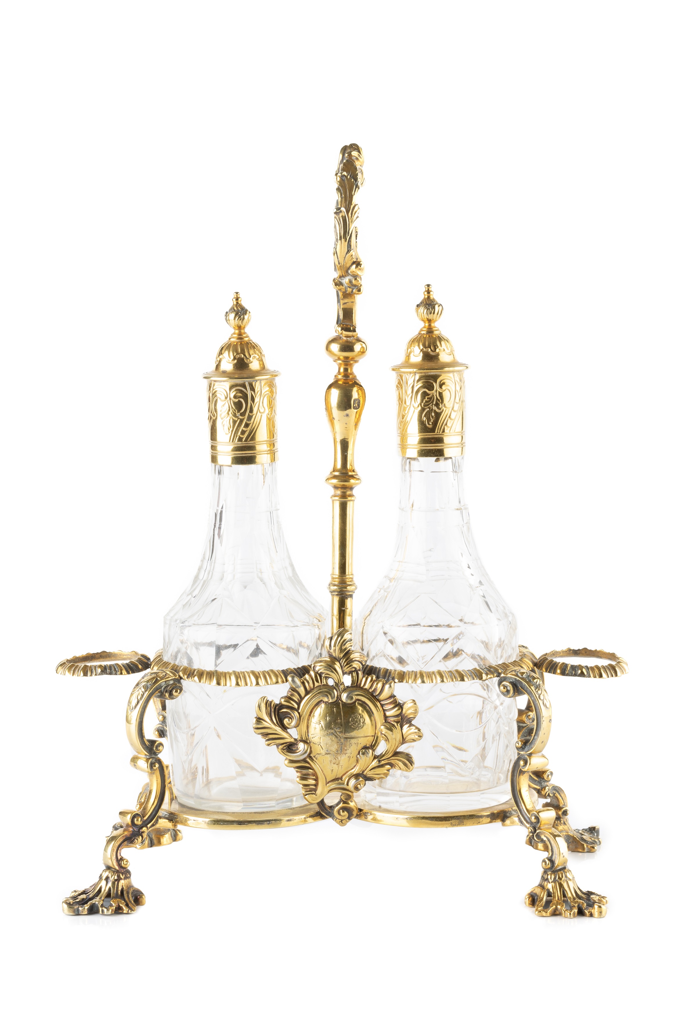 A George III silver-gilt cruet stand, the central foliate loop handle flanked by two gadrooned