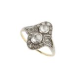 A diamond two stone ring, the two rose-cut stones set within a shaped border further set with