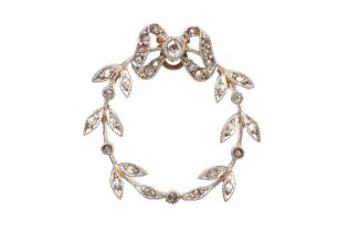 A diamond set wreath brooch, formed of a bow, set with a central millegrain set old mine-cut diamond