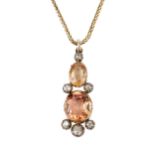 A topaz and diamond pendant, formed from oval orange and slightly smaller orange-brown stones
