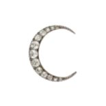 A diamond crescent brooch, set with thirteen graduated brilliant cut stones, the largest approx 0.