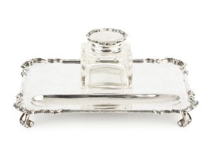 A George V silver inkstand, of shaped rectangular form, fitted with a single square section cut