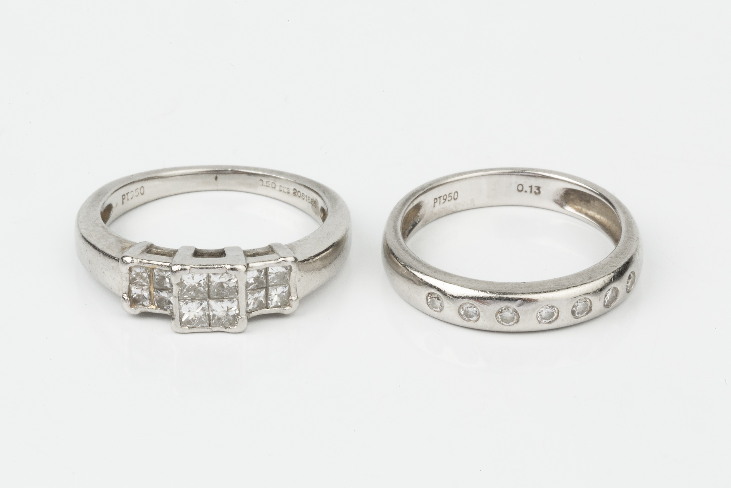 A diamond ring, set with three square panels of four princess cut stones, set in platinum to a plain - Image 3 of 3