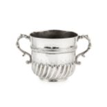 A William III silver porringer, the girdled body with spirally lobed lower section, and having